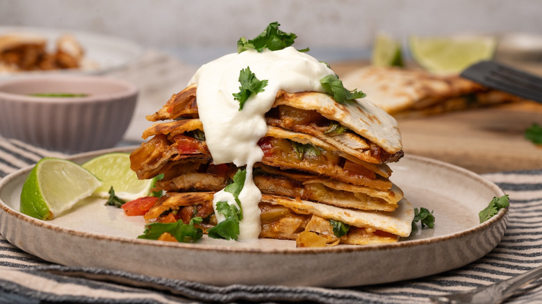 stacked quesadilla slices with sour cream