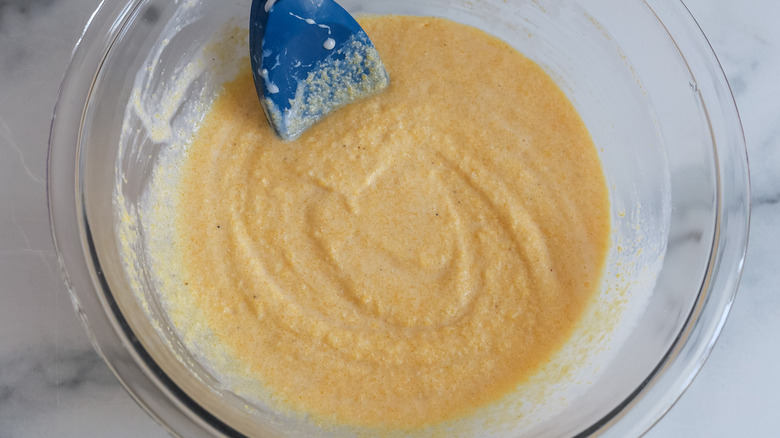 stirring cornmeal buttermilk mixture in bowl