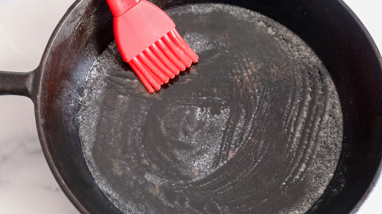 greasing cast iron skillet with brush