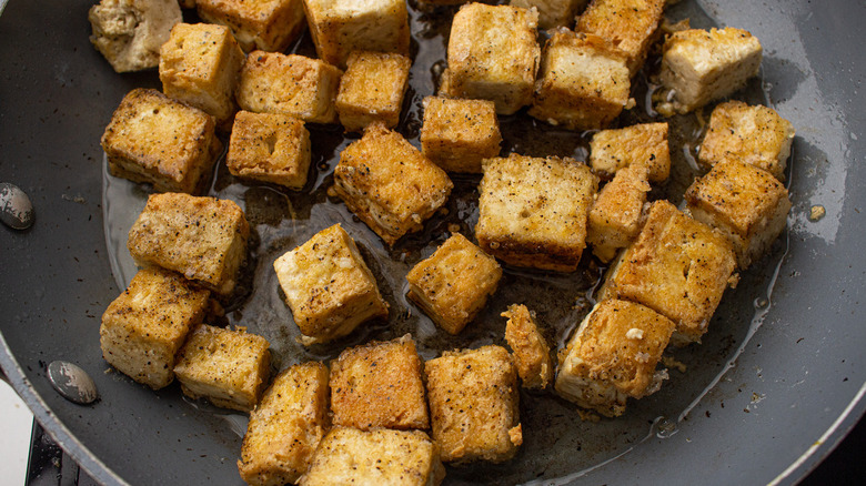 tofu frying in skillet