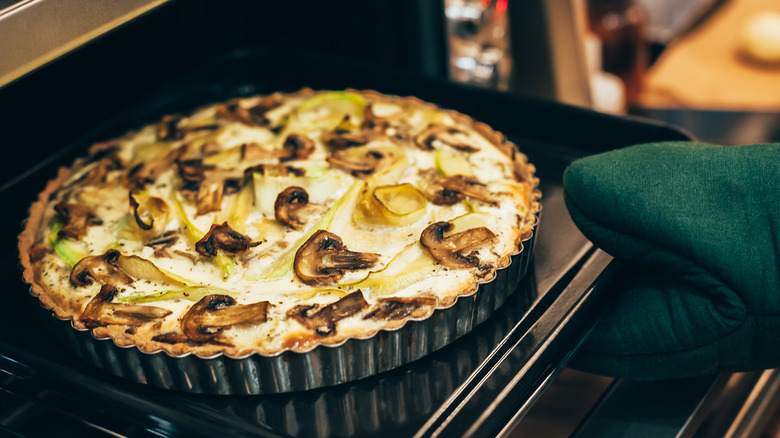 Savory mushroom and cheese tart in oven