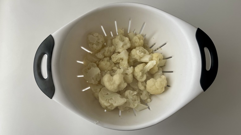 cauliflower florets in strainer 