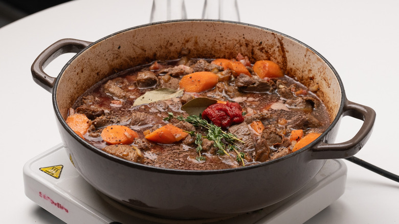 assembling beef bourguignon in pan