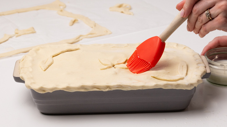 brushing pie lid with milk