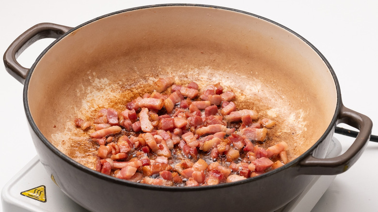 bacon lardons frying in pan