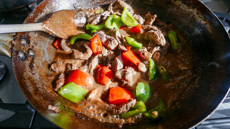 beef in black bean sauce in a wok