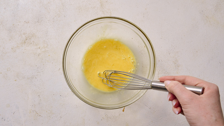 Whisking egg in bowl