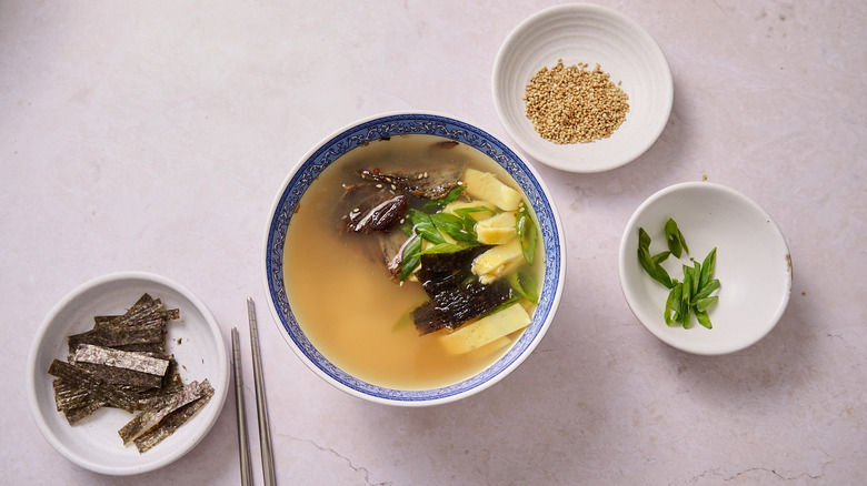 Garnished soup in bowl on table