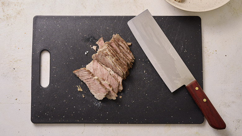 Slicing beef on cutting board