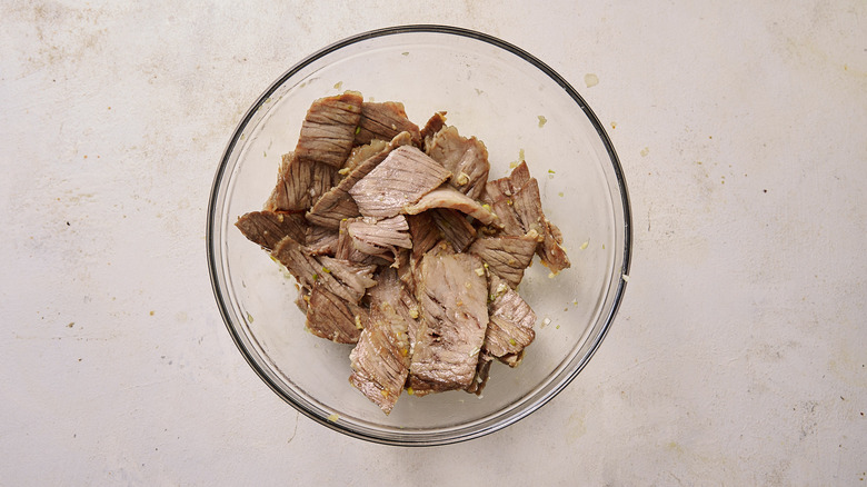 Seasoning beef in bowl