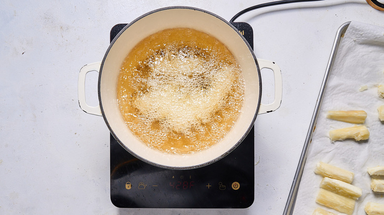 frying yuca in pot