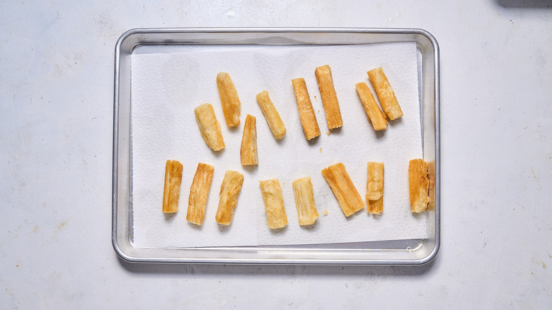 fried yuca root on sheet tray