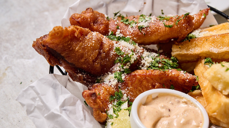 fried fish in basket on table