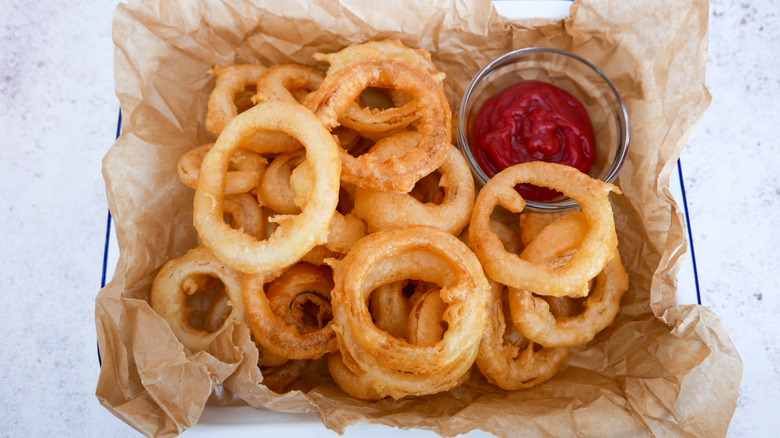 beer-battered onion rings in basket