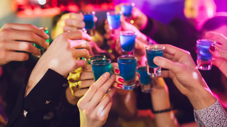 cheersing with shot glasses