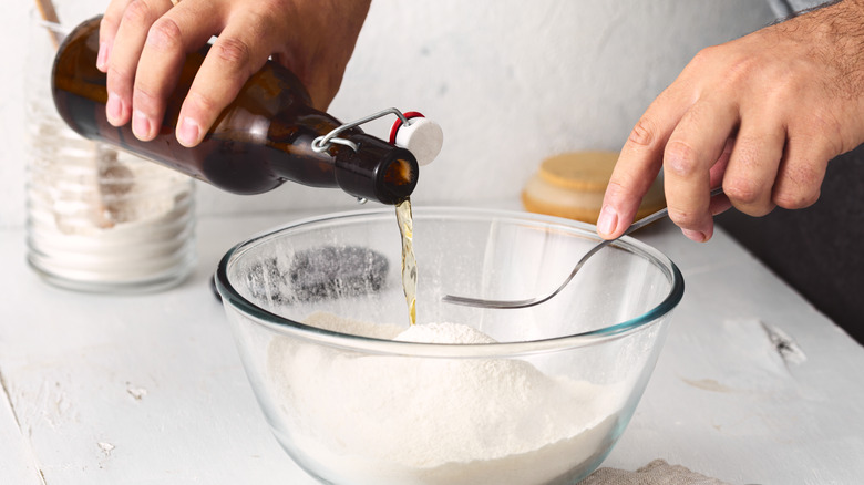 a man adds beer into batter