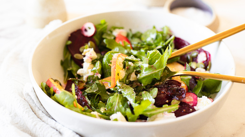 mixed salad with cutlery in bowl