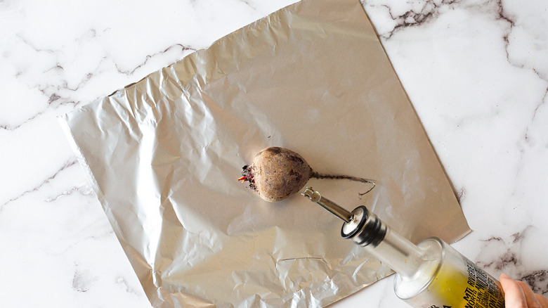 adding oil to beet on foil square