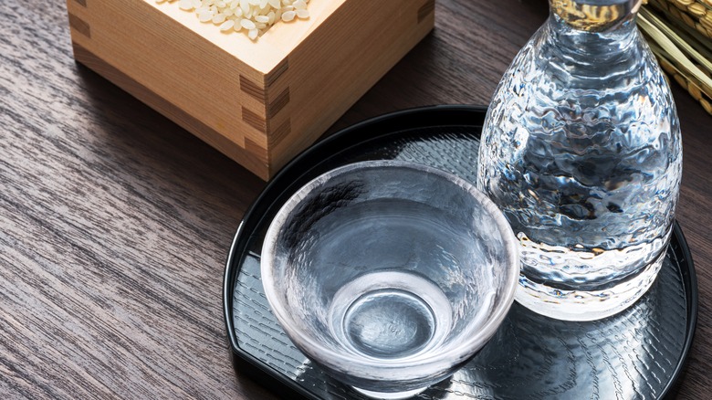 sake in a clear glass and bottle