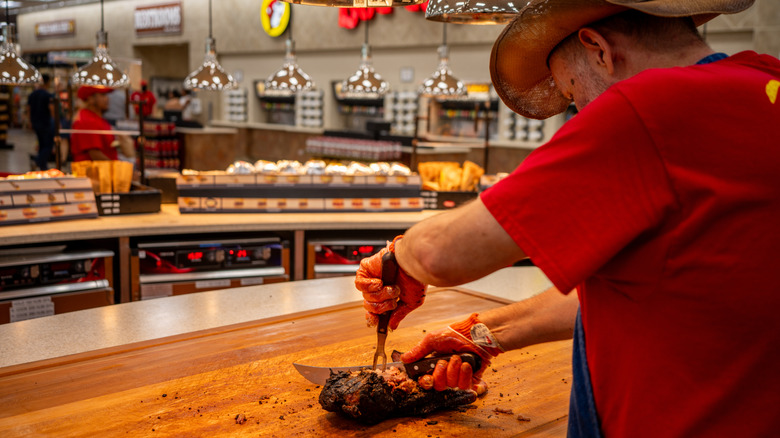 Buc-ee's employee preparing brisket