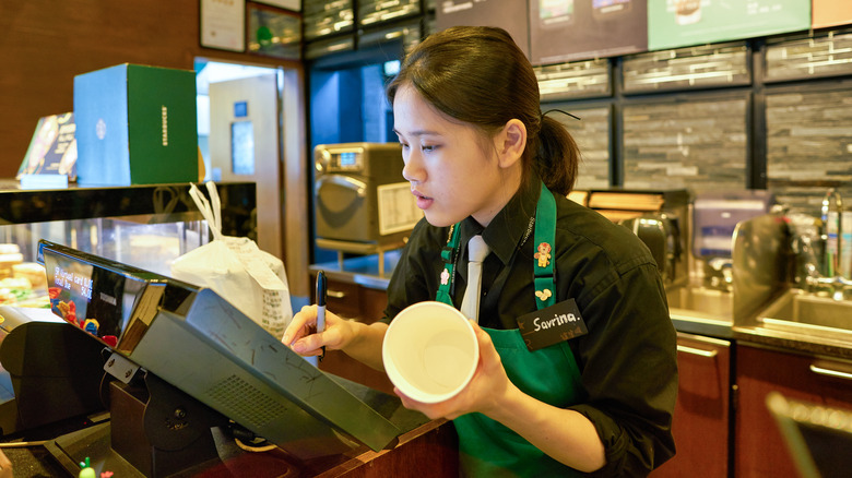 Starbucks employee at cash register