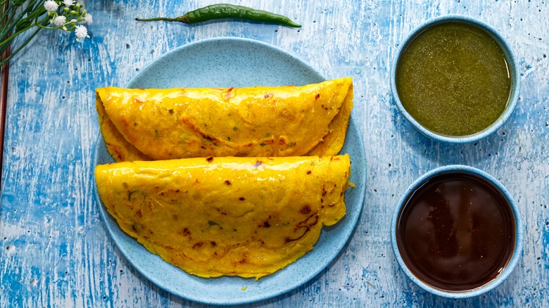 besan chilla with chutney side sauces