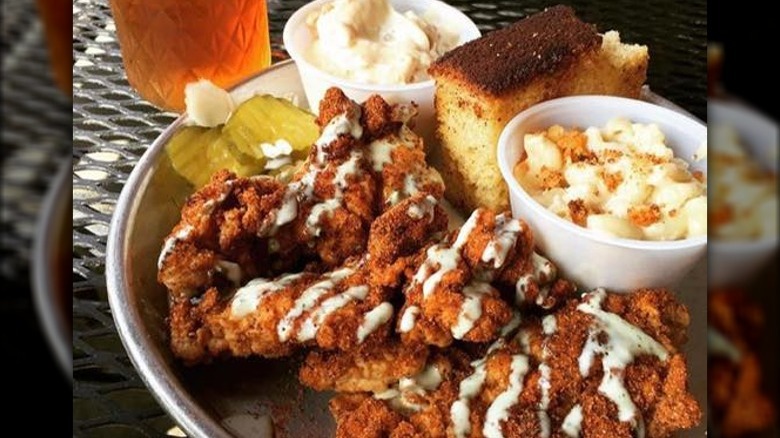 Hot chicken on tray with sides