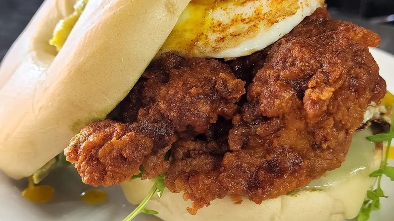 fried chicken with fried egg on bun