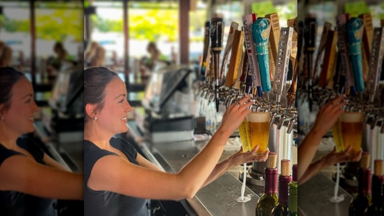 person pouring beer