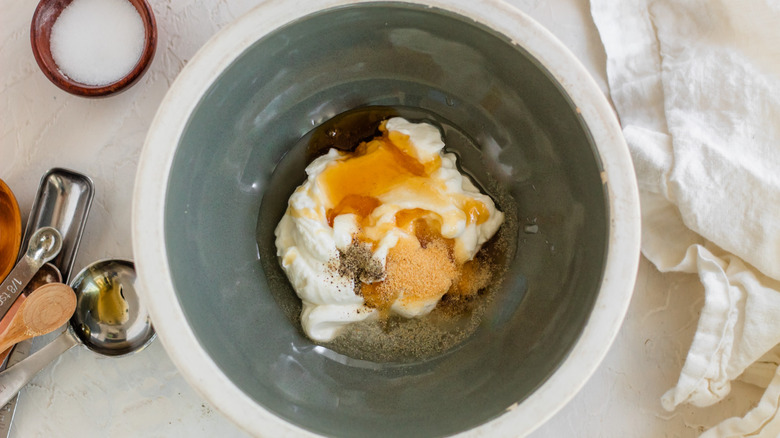 mixing the dressing in a bowl