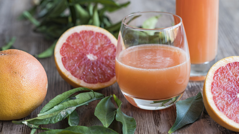 Sliced grapefruit and glass of grapefruit juice