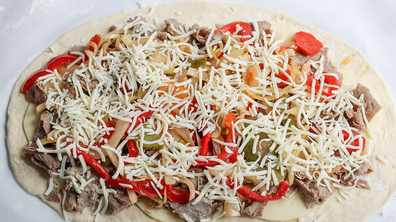 stromboli ingredients on dough 