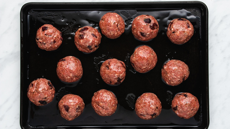 cranberry meatballs on baking sheet 