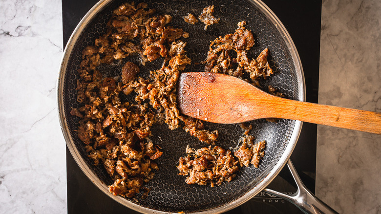 shredded duck meat in pan