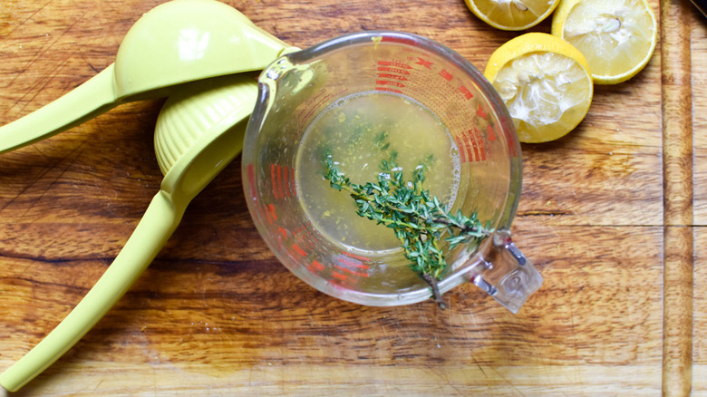 lemon and thyme in measuring cup 