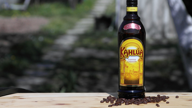 bottle of Kahlua near coffee beans