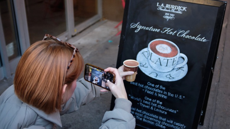 writer taking photo of hot chocolate