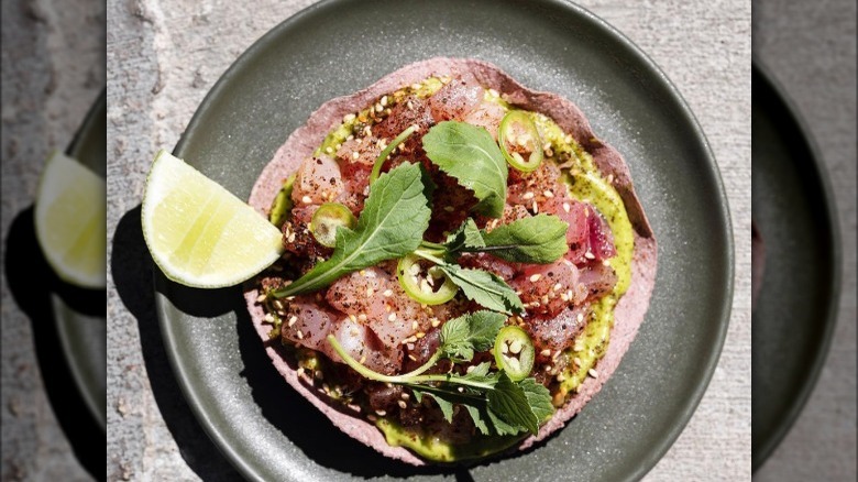 Fish tostada tartare lime on plate 