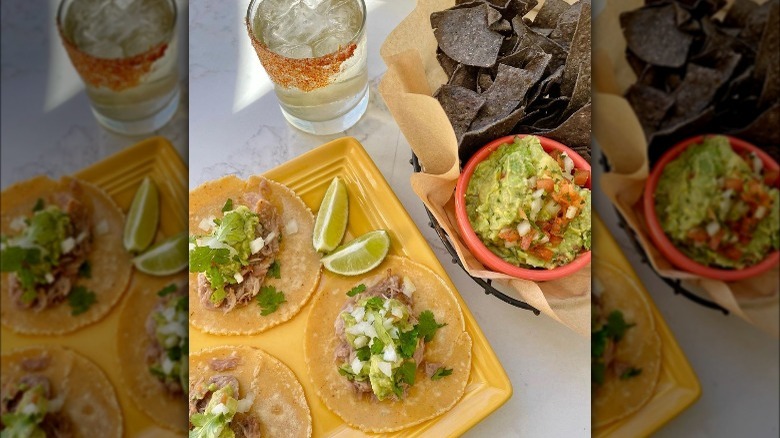 Table setting tacos with chips and guac margarita