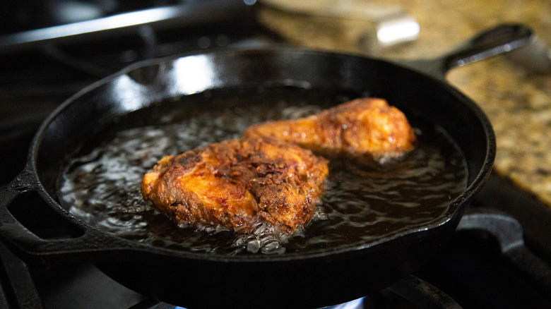 chicken frying in pan