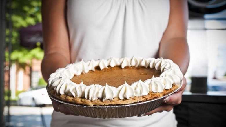 Person holding buttermilk pie