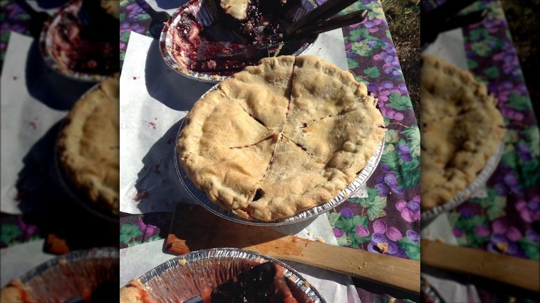 Whole, sliced marionberry pie