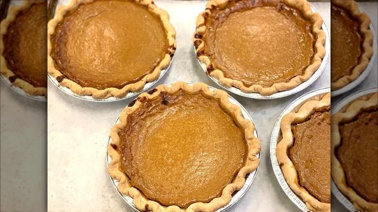 Whole pumpkin pies on counter