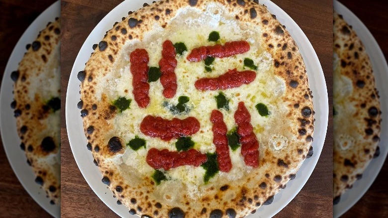 White pizza with green sauce