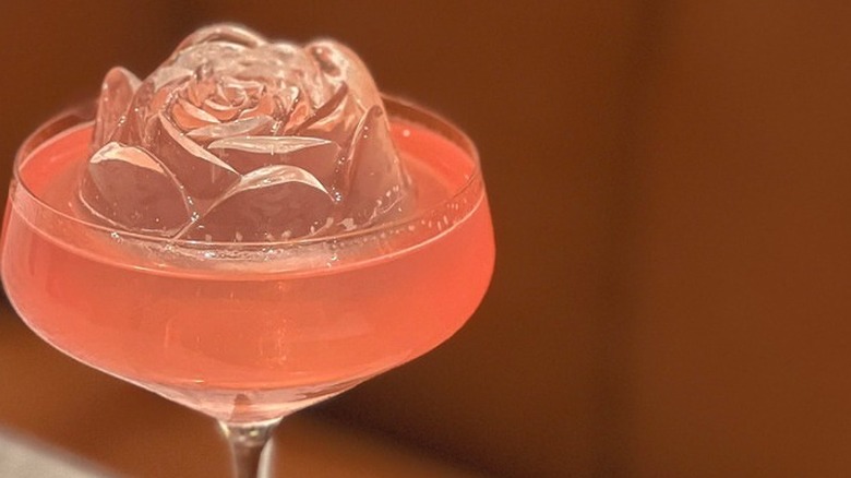 Pink cocktail with blossom-shaped ice
