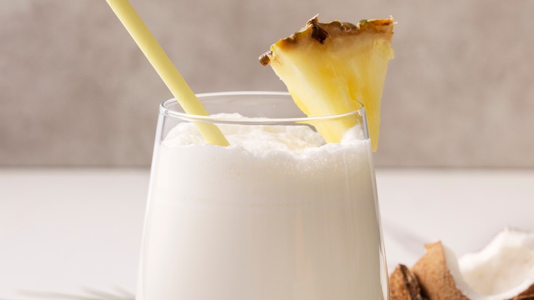 White drink with pineapple glass