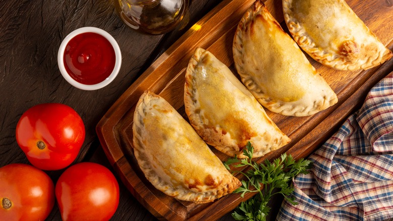 row of empanadas on board