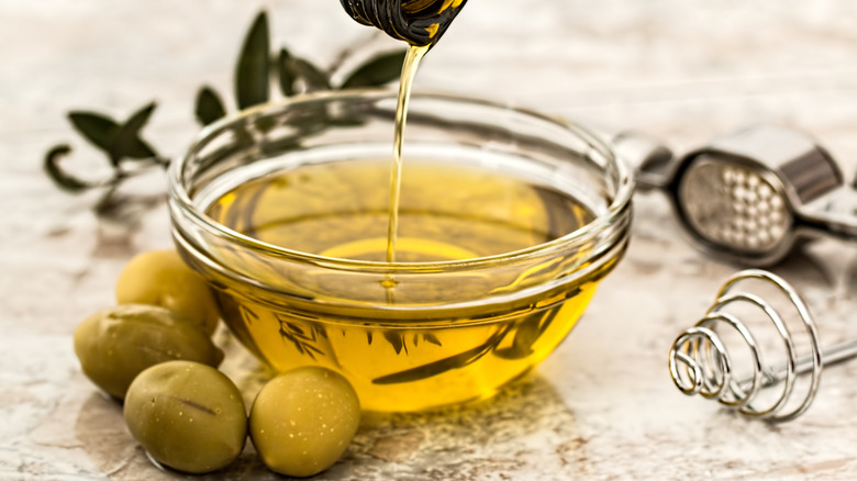 Olive oil pouring into bowl