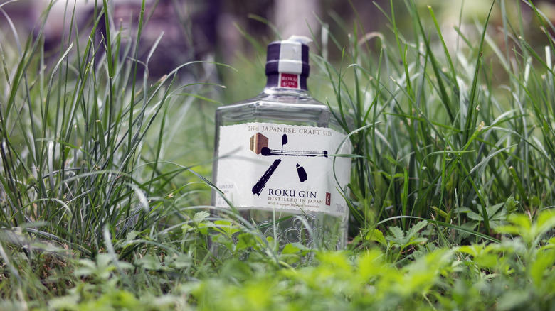 A bottle of Roku gin in the grass