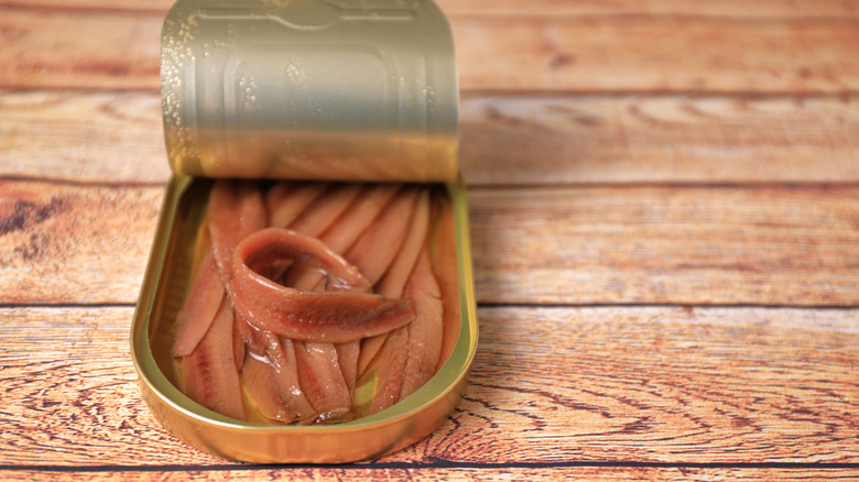 open can of anchovies on a table